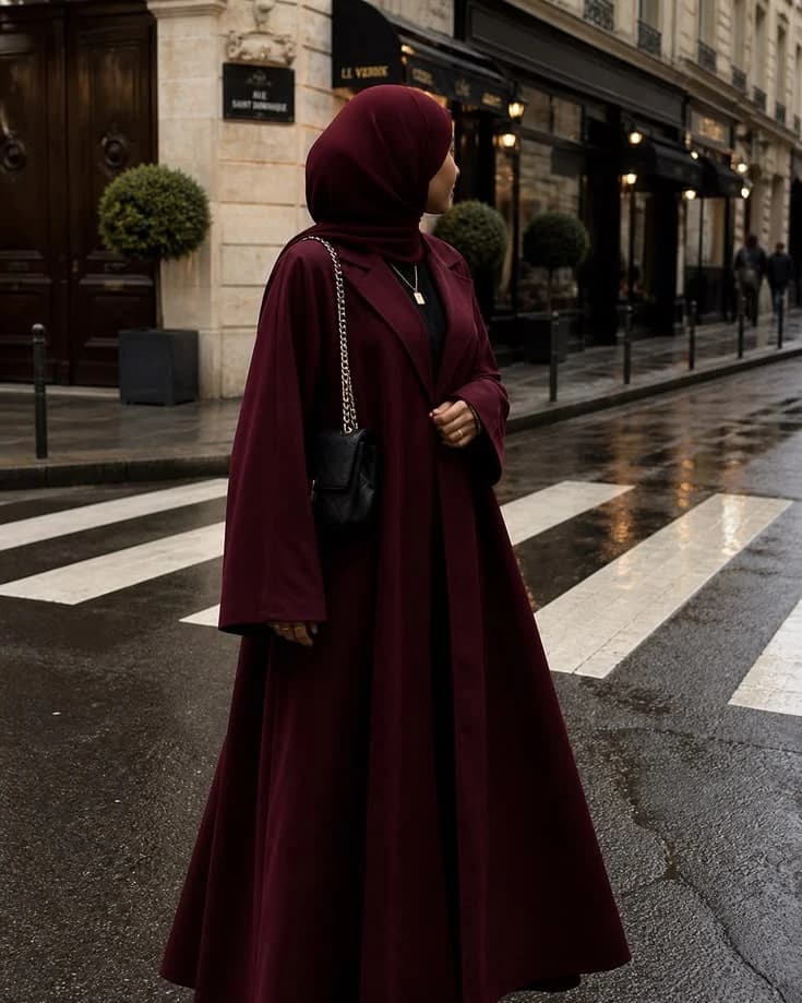 Community member wearing a deep burgundy abaya outdoors