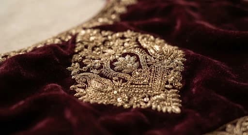 Detailed embroidery on burgundy fabric